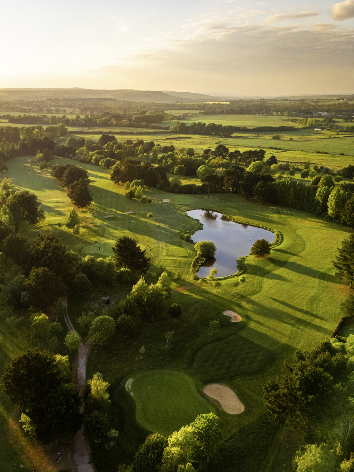 Aerial of a golf course green and bunkers
